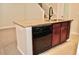 Kitchen island with granite top and black dishwasher at 14003 Citrus Crest Cir, Tampa, FL 33625