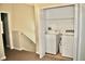 Upper-level laundry room with washer and dryer and built-in shelving at 14003 Citrus Crest Cir, Tampa, FL 33625