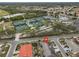 Aerial view showing home location and community amenities including tennis courts at 1601 Woodmar Dr, Sun City Center, FL 33573