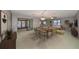 Elegant dining room with a table set for six and access to a patio at 1601 Woodmar Dr, Sun City Center, FL 33573