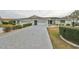Front view of house with driveway and landscaping at 1601 Woodmar Dr, Sun City Center, FL 33573