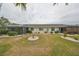 Rear view of house showing exterior features and landscaping at 1601 Woodmar Dr, Sun City Center, FL 33573