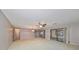 Open living room with neutral carpeting and ample natural light at 1601 Woodmar Dr, Sun City Center, FL 33573