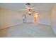 Spacious living room with carpeted floors and ceiling fan at 1601 Woodmar Dr, Sun City Center, FL 33573