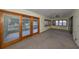 Spacious sunroom, featuring carpet and sliding glass doors at 1601 Woodmar Dr, Sun City Center, FL 33573