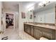 Double vanity bathroom with granite countertops at 16909 April Plush Dr, Wimauma, FL 33598
