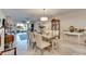 Spacious dining room with seating for six and a view into the living room at 16909 April Plush Dr, Wimauma, FL 33598