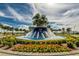 Grand entrance with a stunning water fountain and landscaping at 16909 April Plush Dr, Wimauma, FL 33598