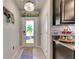 Front entry with stained glass door and tile flooring at 16909 April Plush Dr, Wimauma, FL 33598