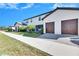 Two-story townhome with two-car garage and landscaped front yard at 16909 April Plush Dr, Wimauma, FL 33598