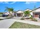 Two-story house with a brown garage door and nicely landscaped yard at 16909 April Plush Dr, Wimauma, FL 33598