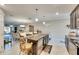 Open concept kitchen with island, granite counters, and stainless steel appliances at 16909 April Plush Dr, Wimauma, FL 33598