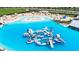 Expansive lagoon pool with inflatable obstacles and floating playground at 16909 April Plush Dr, Wimauma, FL 33598
