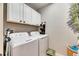 Well-equipped laundry room with washer, dryer, and ample storage at 16909 April Plush Dr, Wimauma, FL 33598