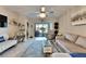 Bright living room with comfy seating, access to patio, and decorative accents at 16909 April Plush Dr, Wimauma, FL 33598