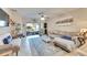 Living room with sectional sofa, access to backyard, and large windows at 16909 April Plush Dr, Wimauma, FL 33598