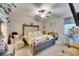 Main bedroom with king-size bed, seating area, and vanity at 16909 April Plush Dr, Wimauma, FL 33598