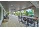 Covered patio with seating and tables overlooking the pool at 16909 April Plush Dr, Wimauma, FL 33598