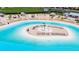 Beach entry pool with central sandbar and lounge chairs at 16909 April Plush Dr, Wimauma, FL 33598