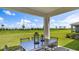 Relaxing covered patio overlooking a lush green backyard at 17932 Tavernside Trl, Lakewood Ranch, FL 34211
