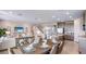Open concept dining room with seating for six and view to backyard at 17932 Tavernside Trl, Lakewood Ranch, FL 34211
