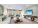Spacious game room with a shuffleboard table, comfortable seating, and large windows at 17932 Tavernside Trl, Lakewood Ranch, FL 34211