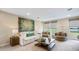 Bright game room with comfortable seating and large windows offering a scenic view at 17932 Tavernside Trl, Lakewood Ranch, FL 34211