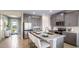 Modern kitchen with gray cabinets, island, and stainless steel appliances at 17932 Tavernside Trl, Lakewood Ranch, FL 34211
