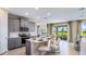 Modern kitchen with gray cabinets, island, and stainless steel appliances at 17932 Tavernside Trl, Lakewood Ranch, FL 34211