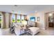 Living area with sectional sofa, large TV, and natural light at 17932 Tavernside Trl, Lakewood Ranch, FL 34211