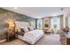 Main bedroom with a plush bed, stylish wallpaper, and plenty of natural light at 17932 Tavernside Trl, Lakewood Ranch, FL 34211