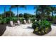 Tranquil outdoor lounge area with palm trees and seating at 17932 Tavernside Trl, Lakewood Ranch, FL 34211