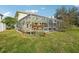 House with a screened pool and backyard at 1919 Blue River Rd, Holiday, FL 34691