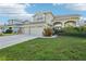 Two-story house with a three-car garage and manicured lawn at 1919 Blue River Rd, Holiday, FL 34691