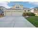 Two-story house with three-car garage and landscaped yard at 1919 Blue River Rd, Holiday, FL 34691