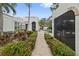 Walkway to a refreshing pool, surrounded by lush landscaping and a cozy fireplace at 220 14Th N Ave, St Petersburg, FL 33701