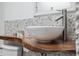 Bathroom with a modern vessel sink and pebble tile backsplash at 220 14Th N Ave, St Petersburg, FL 33701