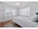 Bedroom with hardwood floors, a white bed, and window treatments at 220 14Th N Ave, St Petersburg, FL 33701