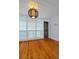 Room with hardwood floors, large windows with blinds, and a unique light fixture at 220 14Th N Ave, St Petersburg, FL 33701