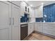 Modern kitchen with white cabinets and blue chevron backsplash at 220 14Th N Ave, St Petersburg, FL 33701