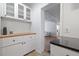 White kitchen cabinets, butcher block countertops, and granite breakfast bar at 220 14Th N Ave, St Petersburg, FL 33701