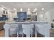 Modern kitchen with white cabinets and blue chevron backsplash at 220 14Th N Ave, St Petersburg, FL 33701