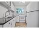 Small galley kitchen with white cabinets and granite countertops at 220 14Th N Ave, St Petersburg, FL 33701