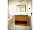 Stylish bathroom with a freestanding vanity and a sleek mirror at 225 Tournament Rd, Rotonda West, FL 33947