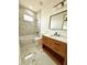 Elegant bathroom featuring a wooden vanity and marble shower at 225 Tournament Rd, Rotonda West, FL 33947