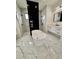 Bathroom with freestanding tub, walk-in shower, and marble floors at 225 Tournament Rd, Rotonda West, FL 33947