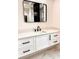 Modern bathroom vanity with white cabinets and black hardware at 225 Tournament Rd, Rotonda West, FL 33947