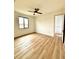 Bright bedroom with large window and wood-look floors at 225 Tournament Rd, Rotonda West, FL 33947