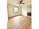 Bright bedroom with hardwood floors and access to bathroom at 225 Tournament Rd, Rotonda West, FL 33947