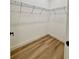 Spacious walk-in closet with wire shelving and light wood floors at 225 Tournament Rd, Rotonda West, FL 33947